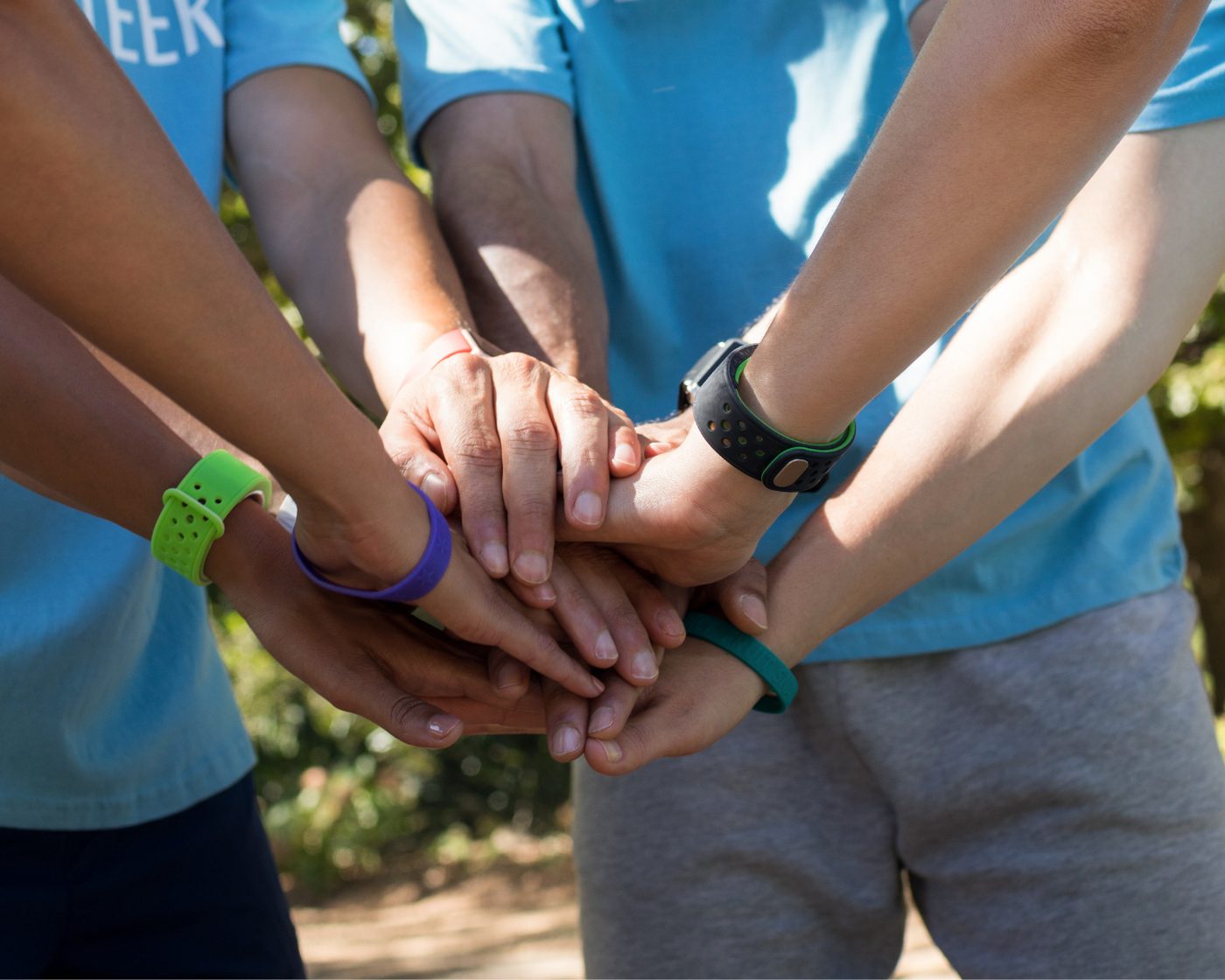 Volunteer service day — hands stacked
