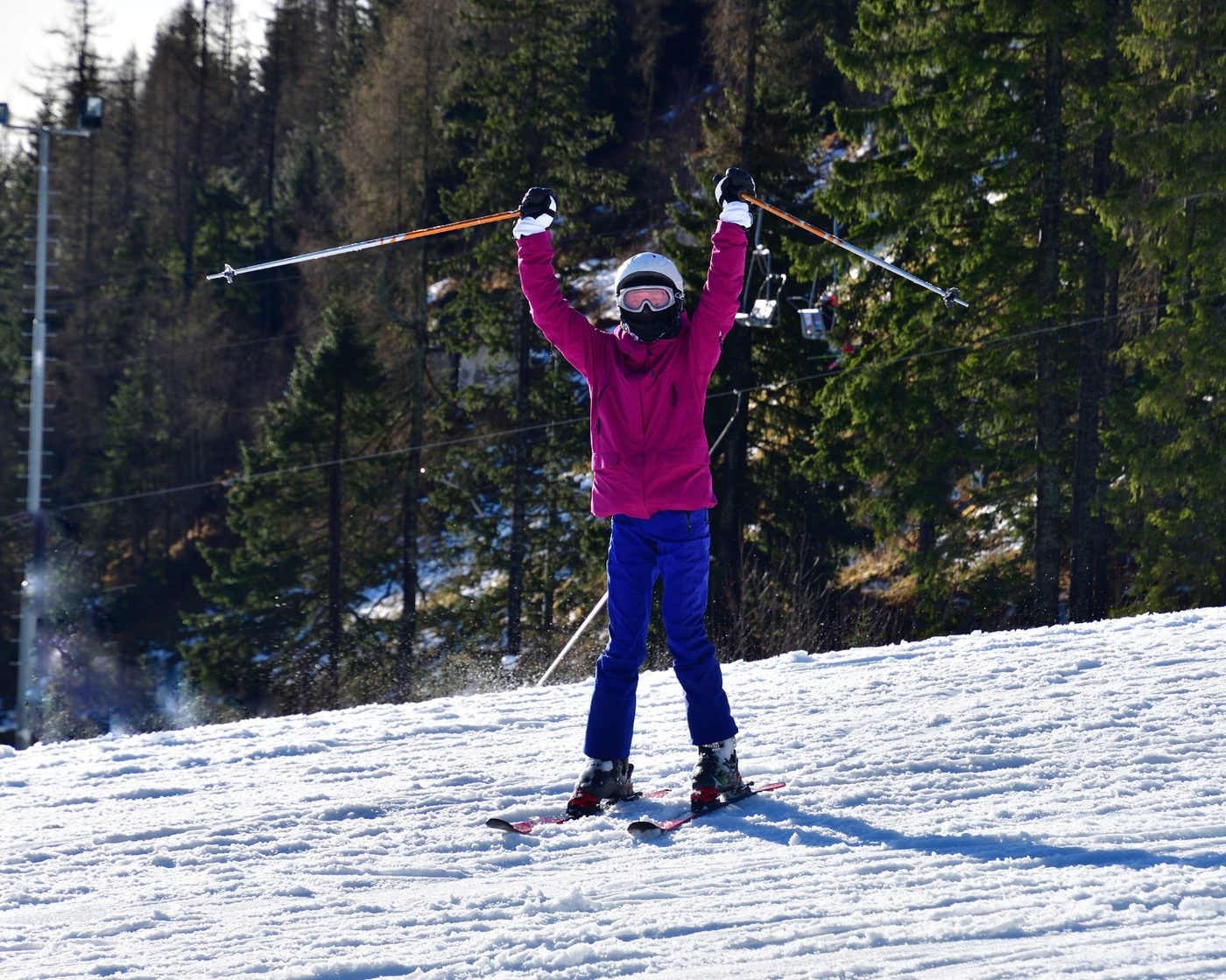Skier with arms raised in triumph